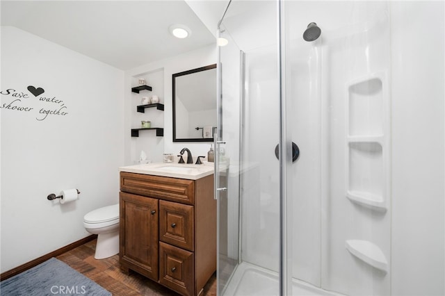 bathroom featuring a shower with shower door, vanity, toilet, and hardwood / wood-style flooring