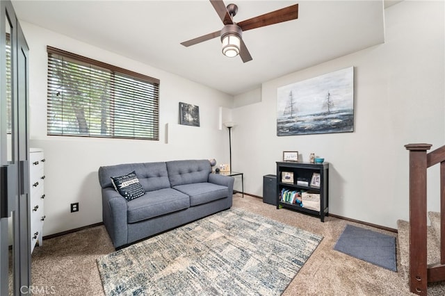 carpeted living room with ceiling fan