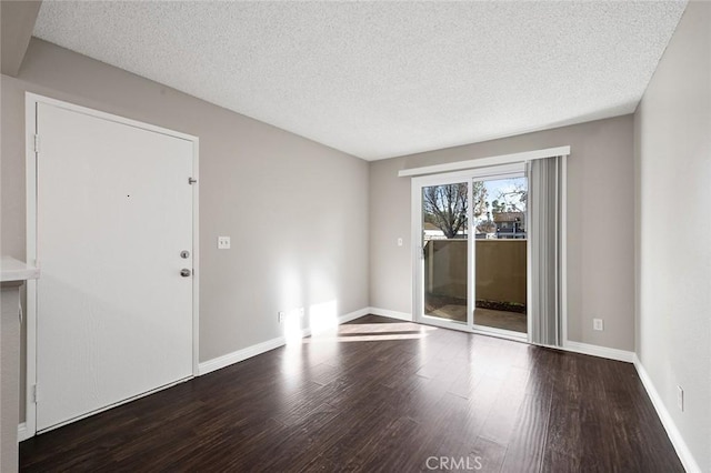 unfurnished room with a textured ceiling and hardwood / wood-style flooring