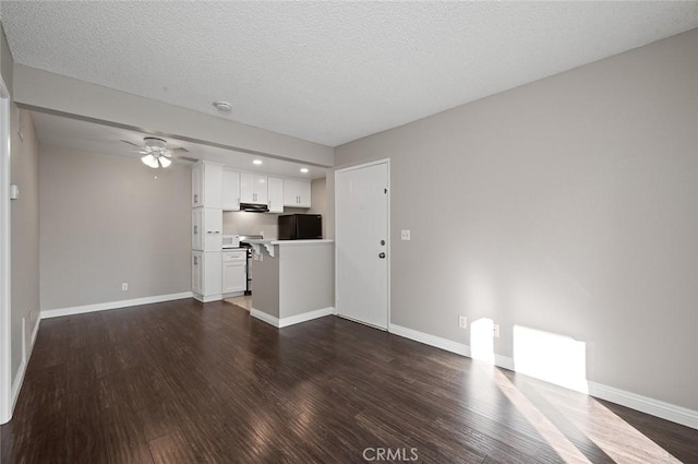 unfurnished living room featuring a textured ceiling, ceiling fan, and dark hardwood / wood-style floors