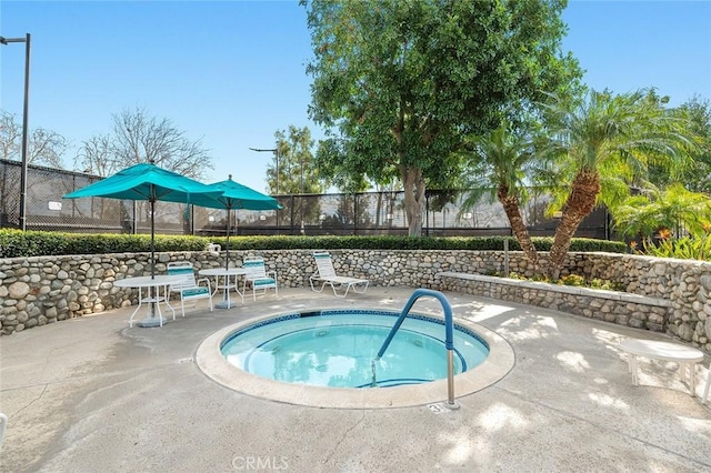 view of swimming pool with a patio and a community hot tub