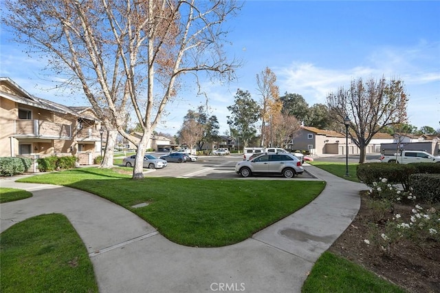 view of property's community with a lawn