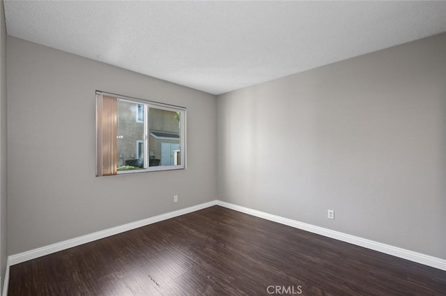 unfurnished room with hardwood / wood-style flooring