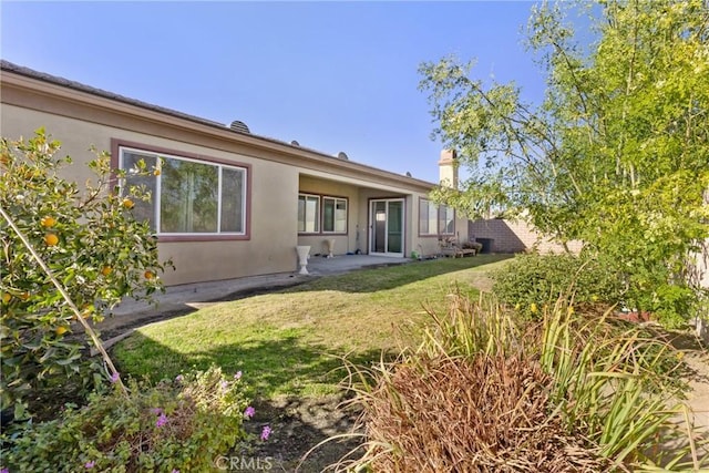 rear view of house with a lawn