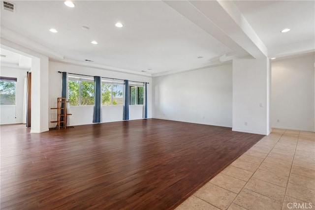 spare room featuring a healthy amount of sunlight and light hardwood / wood-style floors