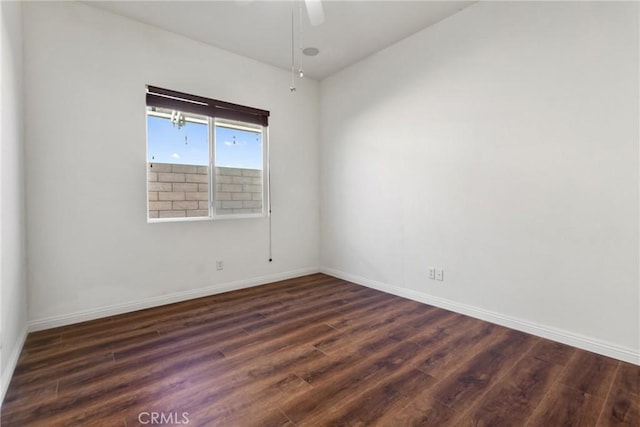 spare room with ceiling fan and dark hardwood / wood-style floors