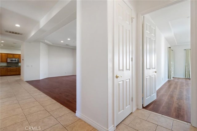 corridor featuring light tile patterned floors