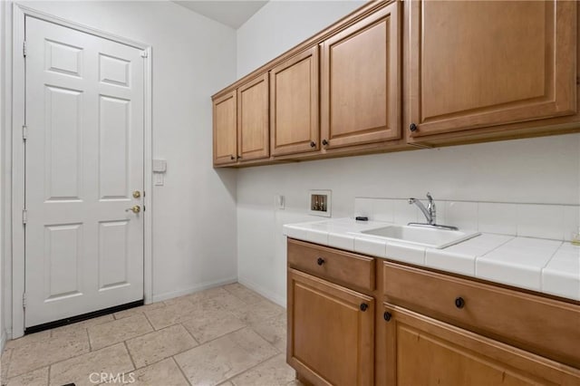 laundry area featuring cabinets, sink, and washer hookup