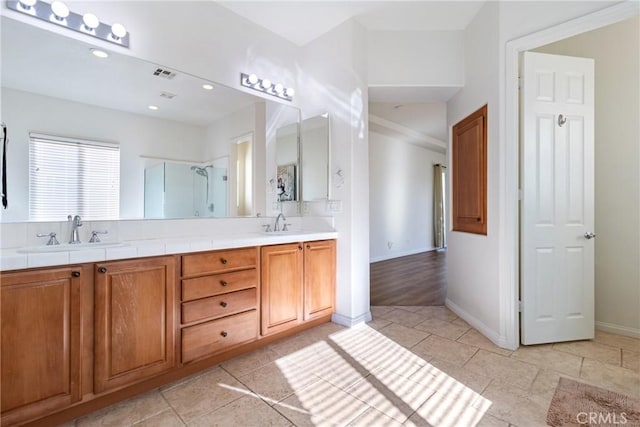 bathroom with an enclosed shower and vanity