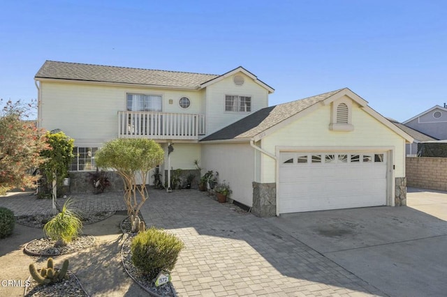 view of front of house featuring a garage and a balcony