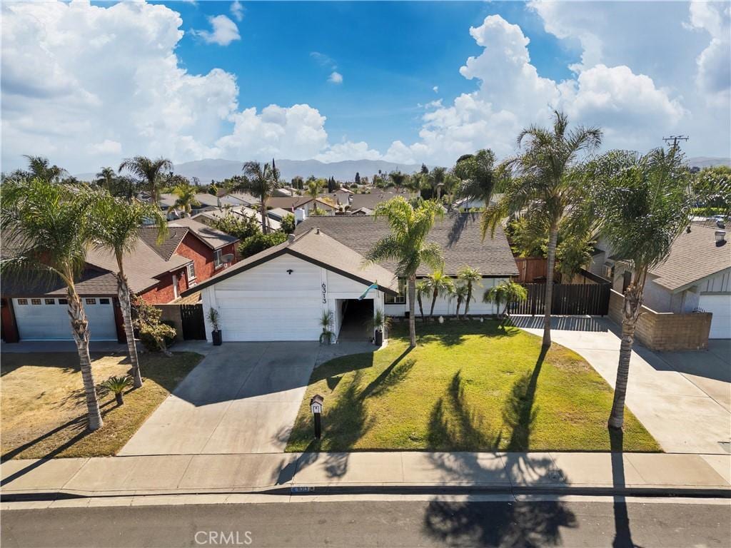 view of front of property with a front lawn and a garage