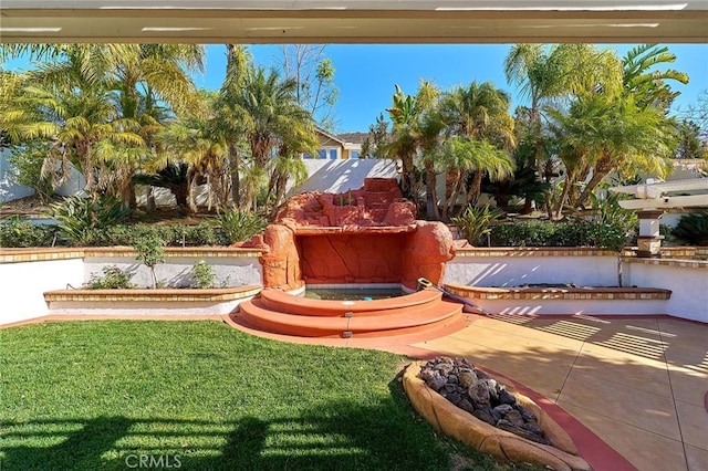 view of property's community with a patio area and a yard