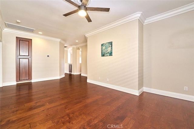 unfurnished room featuring ceiling fan, dark hardwood / wood-style flooring, and crown molding