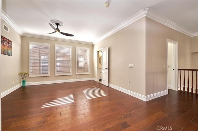 spare room with ceiling fan, dark wood-type flooring, and crown molding