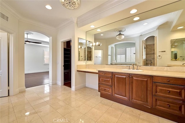 bathroom with ceiling fan, vanity, tile patterned floors, crown molding, and a shower