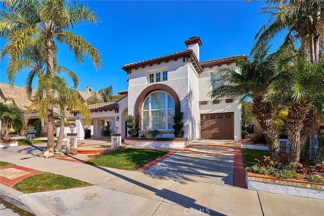 mediterranean / spanish house featuring a garage