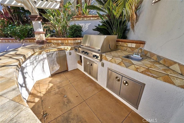 view of patio / terrace featuring exterior kitchen, sink, and grilling area