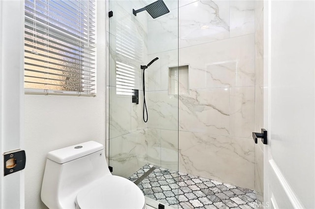 bathroom featuring toilet and a tile shower