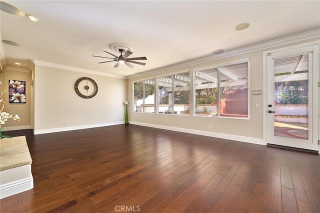 empty room featuring ceiling fan, dark wood-type flooring, and crown molding