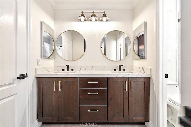 bathroom with toilet, vanity, and crown molding