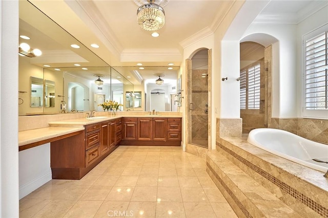 bathroom featuring an inviting chandelier, separate shower and tub, tile patterned floors, ornamental molding, and vanity