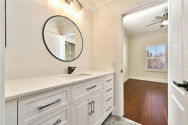 bathroom featuring ceiling fan, vanity, wood-type flooring, and crown molding