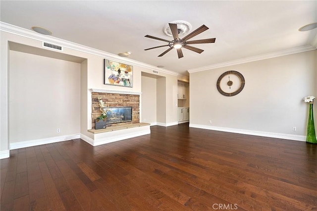 unfurnished living room with ceiling fan, dark wood-type flooring, ornamental molding, and a fireplace