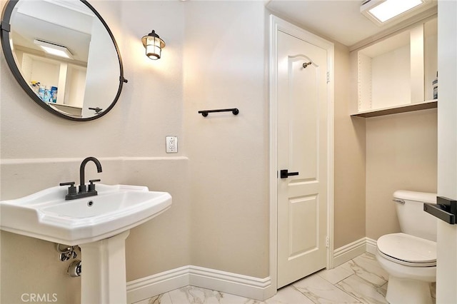 bathroom featuring sink and toilet