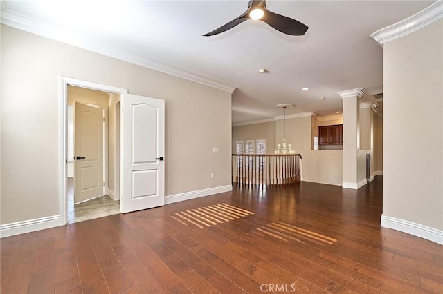 unfurnished room with dark wood-type flooring, ornamental molding, and ceiling fan with notable chandelier