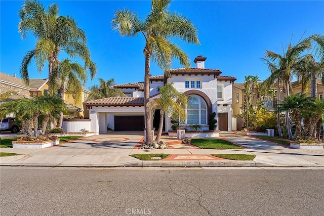 mediterranean / spanish-style house with a garage