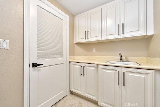 kitchen with sink and white cabinetry