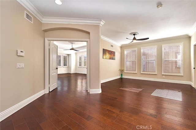 spare room with ornamental molding and dark hardwood / wood-style flooring