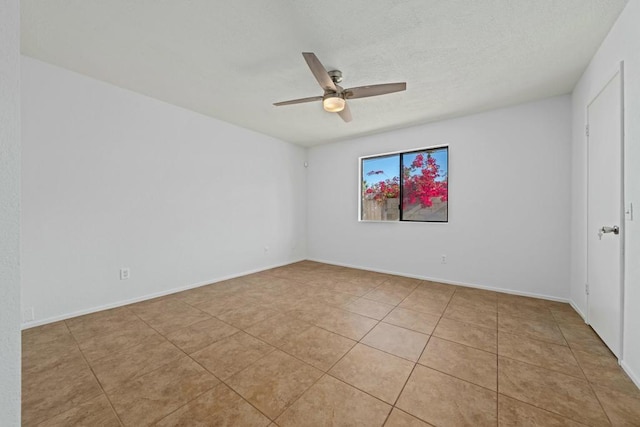 tiled empty room featuring ceiling fan