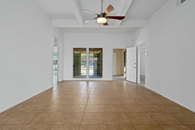 tiled empty room featuring ceiling fan, a high ceiling, and beamed ceiling