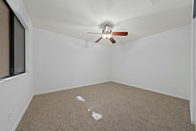 empty room with ceiling fan and carpet floors