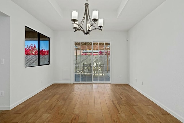 unfurnished dining area featuring an inviting chandelier