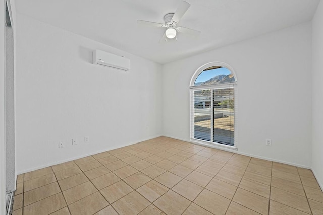 spare room with ceiling fan, a wall mounted AC, and light tile patterned flooring