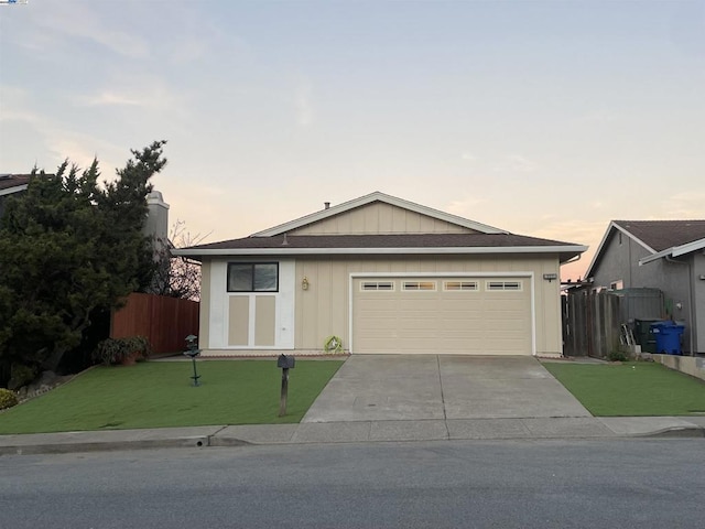 ranch-style house featuring a yard and a garage