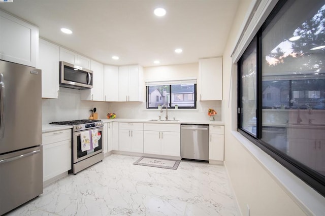 kitchen featuring white cabinetry and appliances with stainless steel finishes