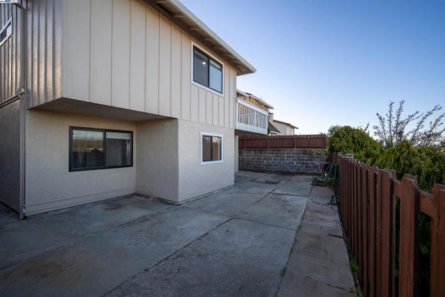 view of side of property featuring a patio area