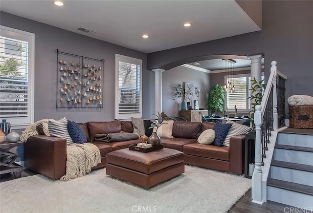 living room featuring ornate columns and ornamental molding