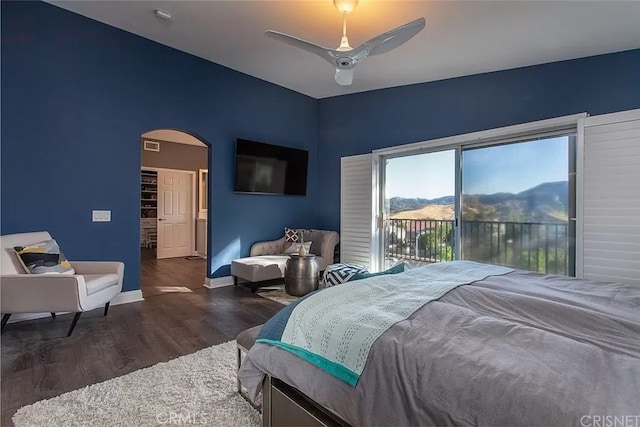 bedroom featuring ceiling fan, access to outside, and dark hardwood / wood-style flooring