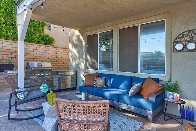 view of patio with exterior kitchen, outdoor lounge area, and grilling area