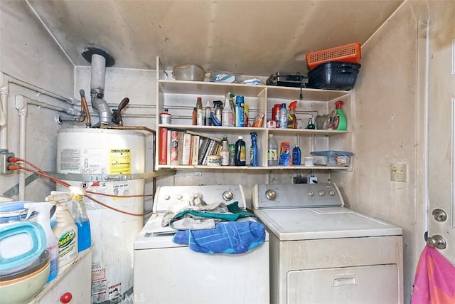 laundry area featuring water heater and washer and clothes dryer