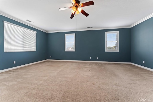 carpeted empty room with ceiling fan and ornamental molding