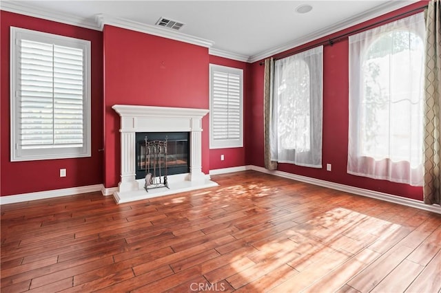 unfurnished living room featuring crown molding and wood-type flooring