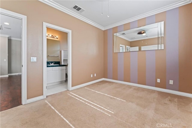 unfurnished room with ornamental molding and carpet