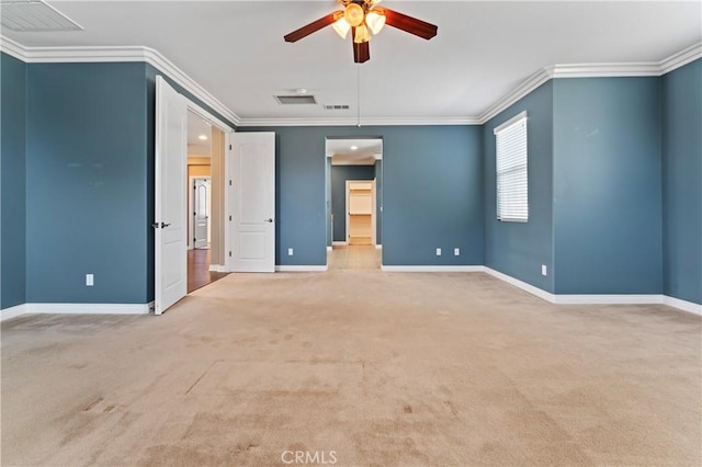 empty room with crown molding, carpet floors, and ceiling fan