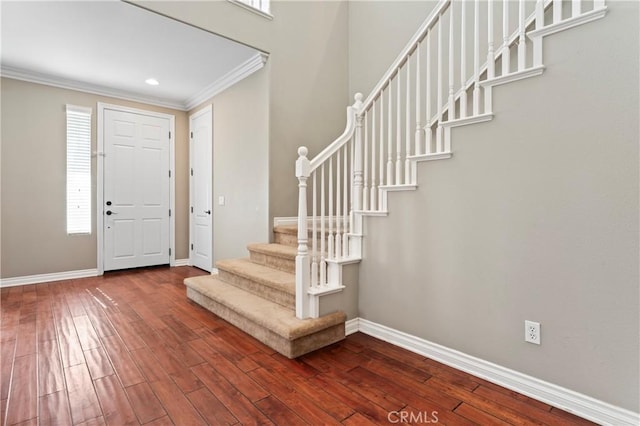 foyer featuring ornamental molding and wood-type flooring