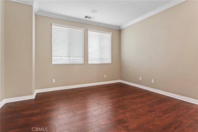 spare room with crown molding and dark hardwood / wood-style floors